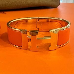 Hermes orange and Gold GM Clic Clac bracelet.